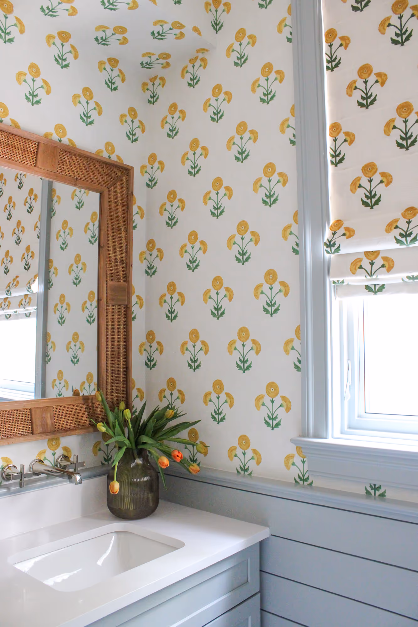 Bright floral wallpaper and modern bathroom design in Arlington, VA featuring a sleek sink and elegant mirror.