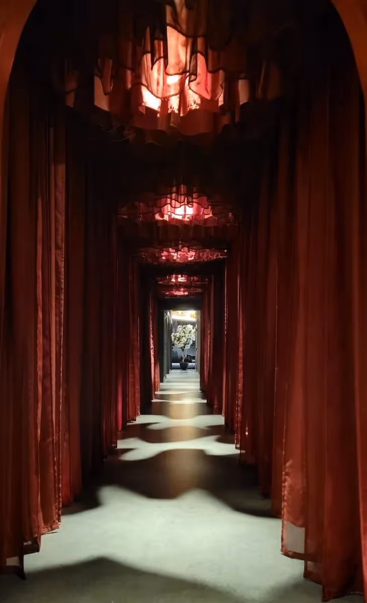 Komodo restaurant hallway with red drapery