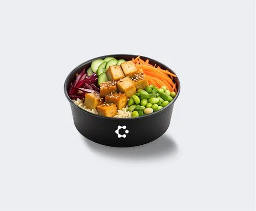 A black bowl with green soup topped with croutons and herbs, featuring a white Circus icon on the front.