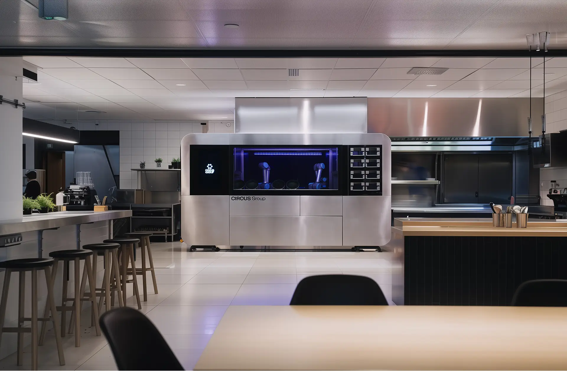 CA-1 Series 4 robotic kitchen by CIRCUS Group installed in a modern campus dining area, with a sleek stainless steel finish and dual robotic arms in a commercial kitchen environment.