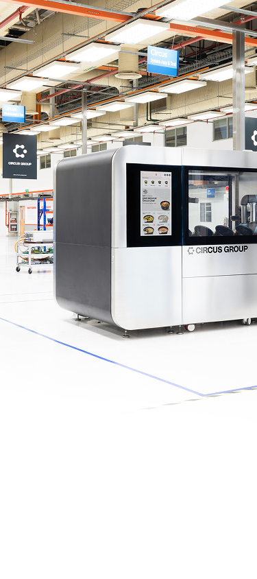 Modern industrial robot machine with a touchscreen interface inside a bright, spacious factory labeled Circus Group.