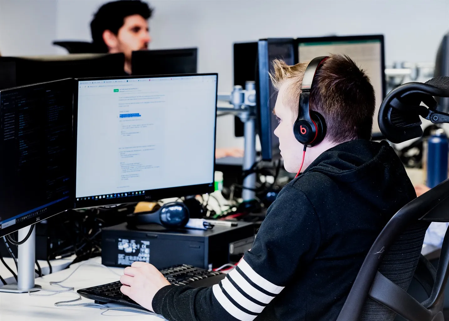 Team member programming at their desk, on their computer