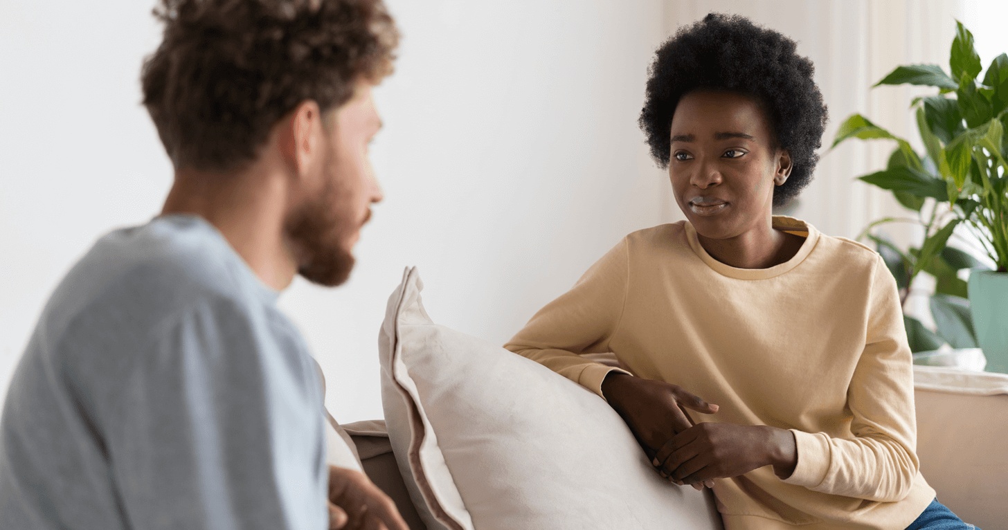 Man and woman having a supportive conversation during therapy session at the best mental health clinic in San Jose.