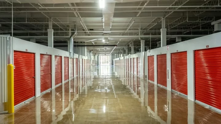 Indoor storage facility with red doors.