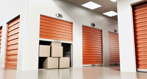 Indoor orange self-storage units with boxes.