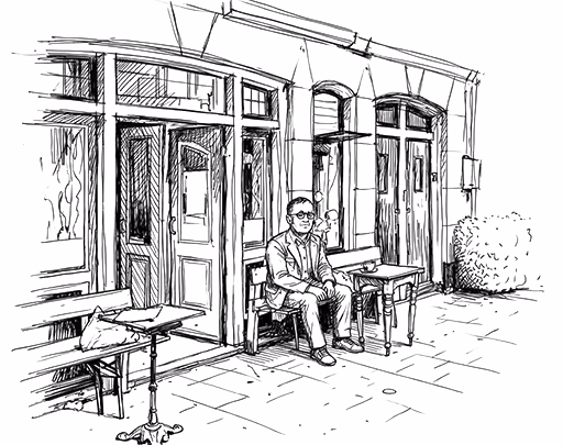 Man zittend op een bankje buiten een gebouw met grote ramen en houten deuren.