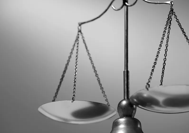 Close-up of a black and white balanced scale symbolizing justice.