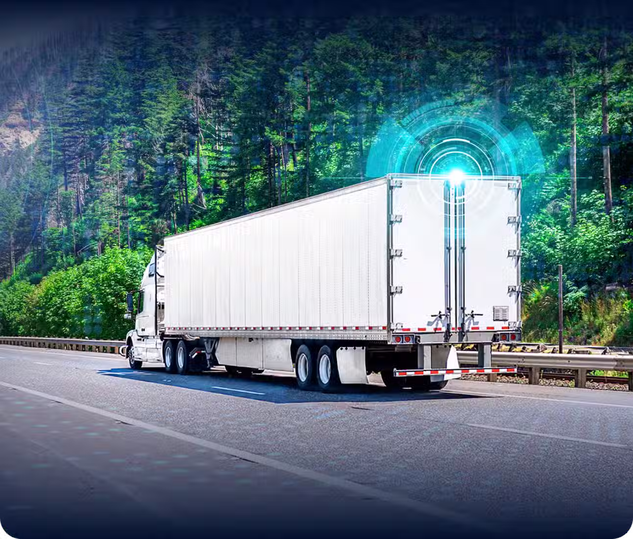 White semi-truck driving on highway surrounded by green forest with a digital blue light indicator on the back.