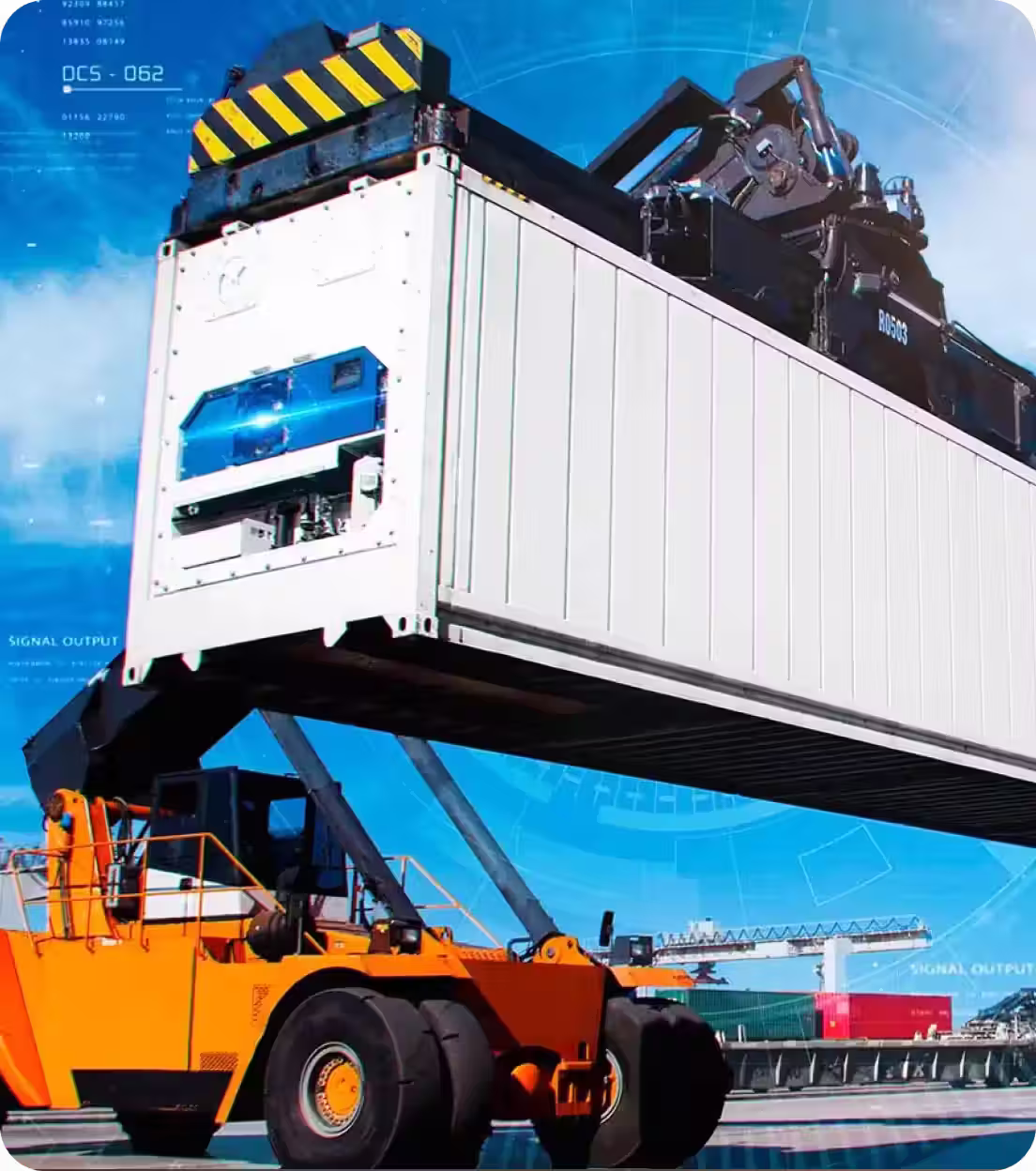 Orange container handler lifting a large white refrigerated shipping container at a port.