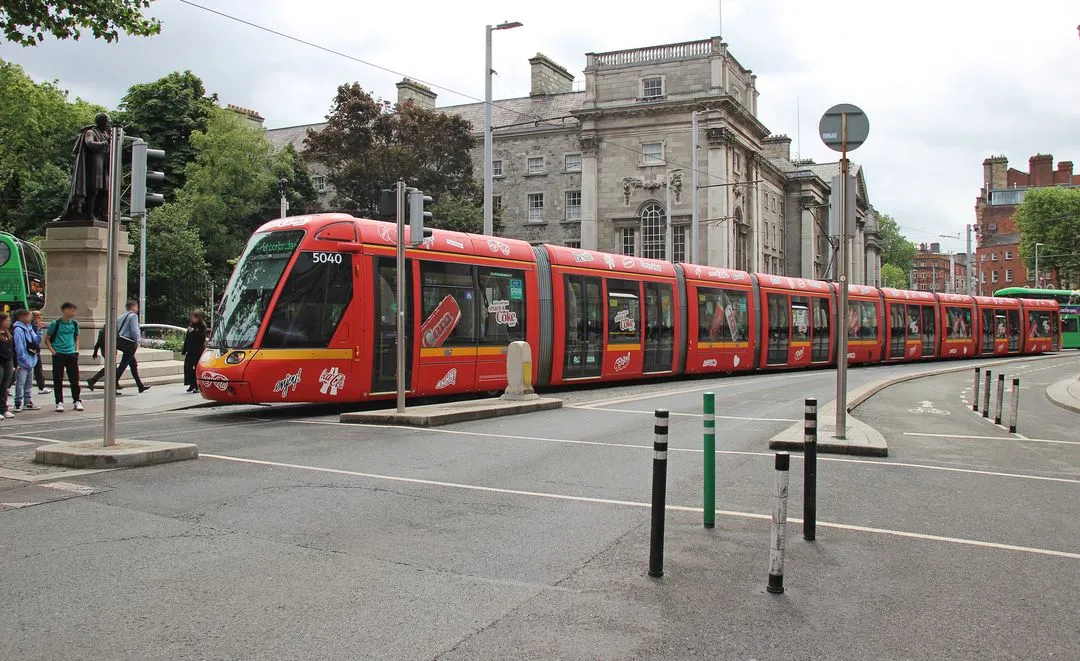 A Luas Full Wrap for Coca-Cola, passing through Dublin city centre past Trinity College