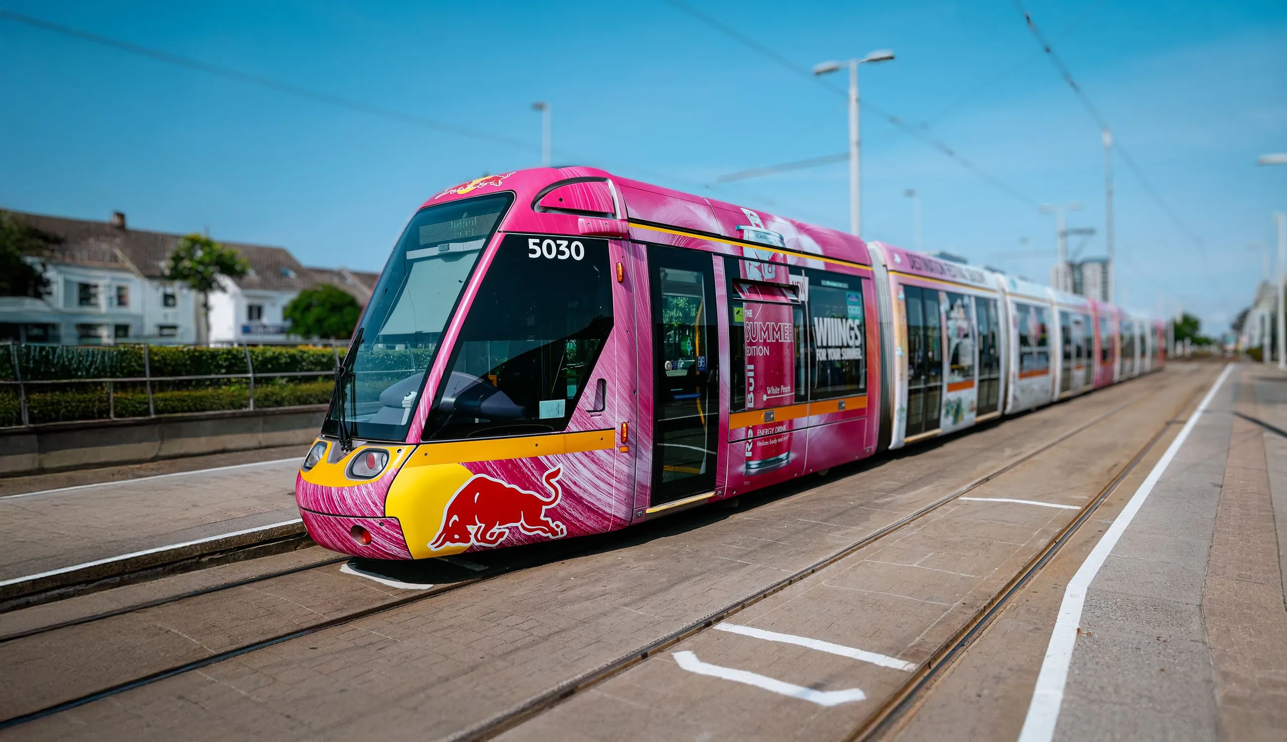 Luas Tram fully wrapped in bright pink and white for Red Bull Summer Edition