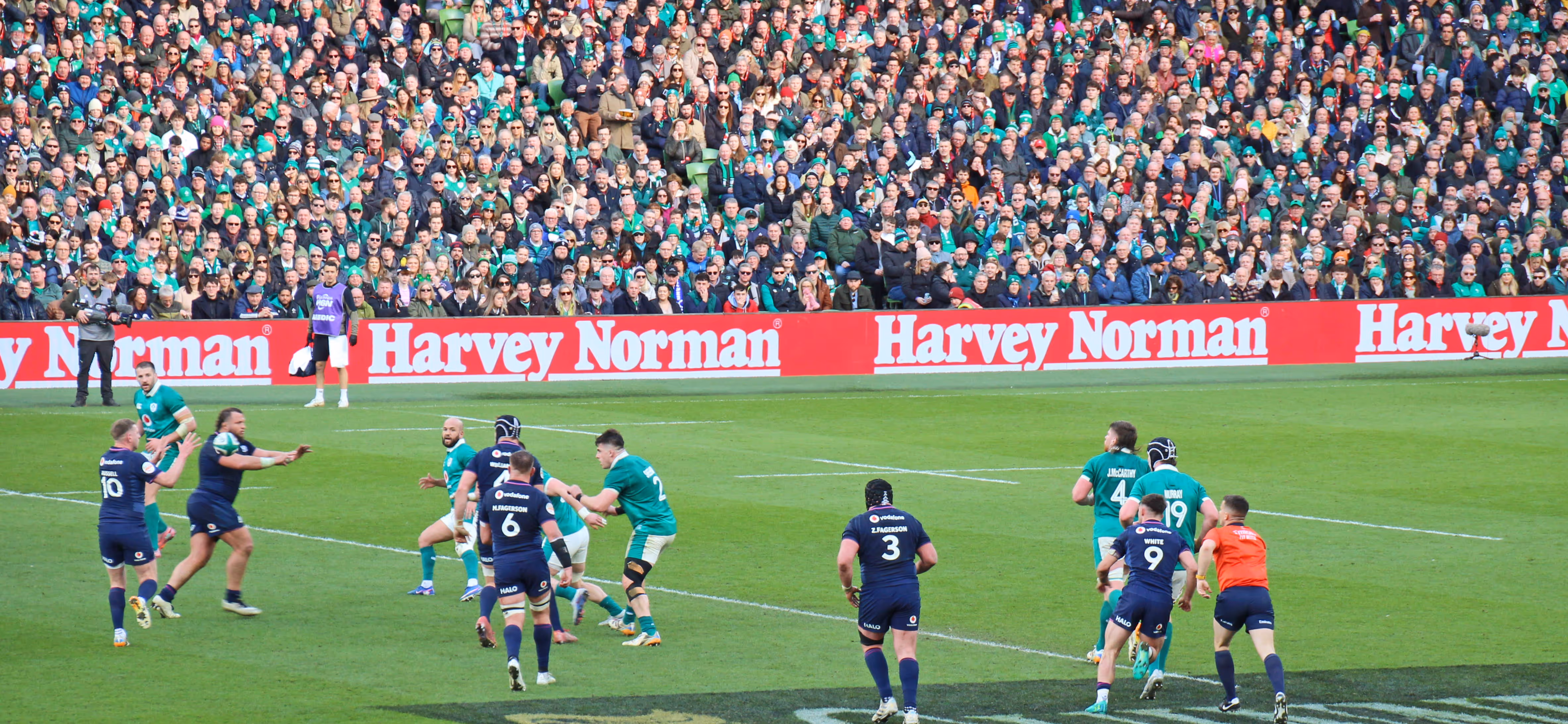 A pitch-side LED advertising board displaying Dexcom, with players competing for a lineout in the foreground during Ireland & France, in the Aviva Stadium