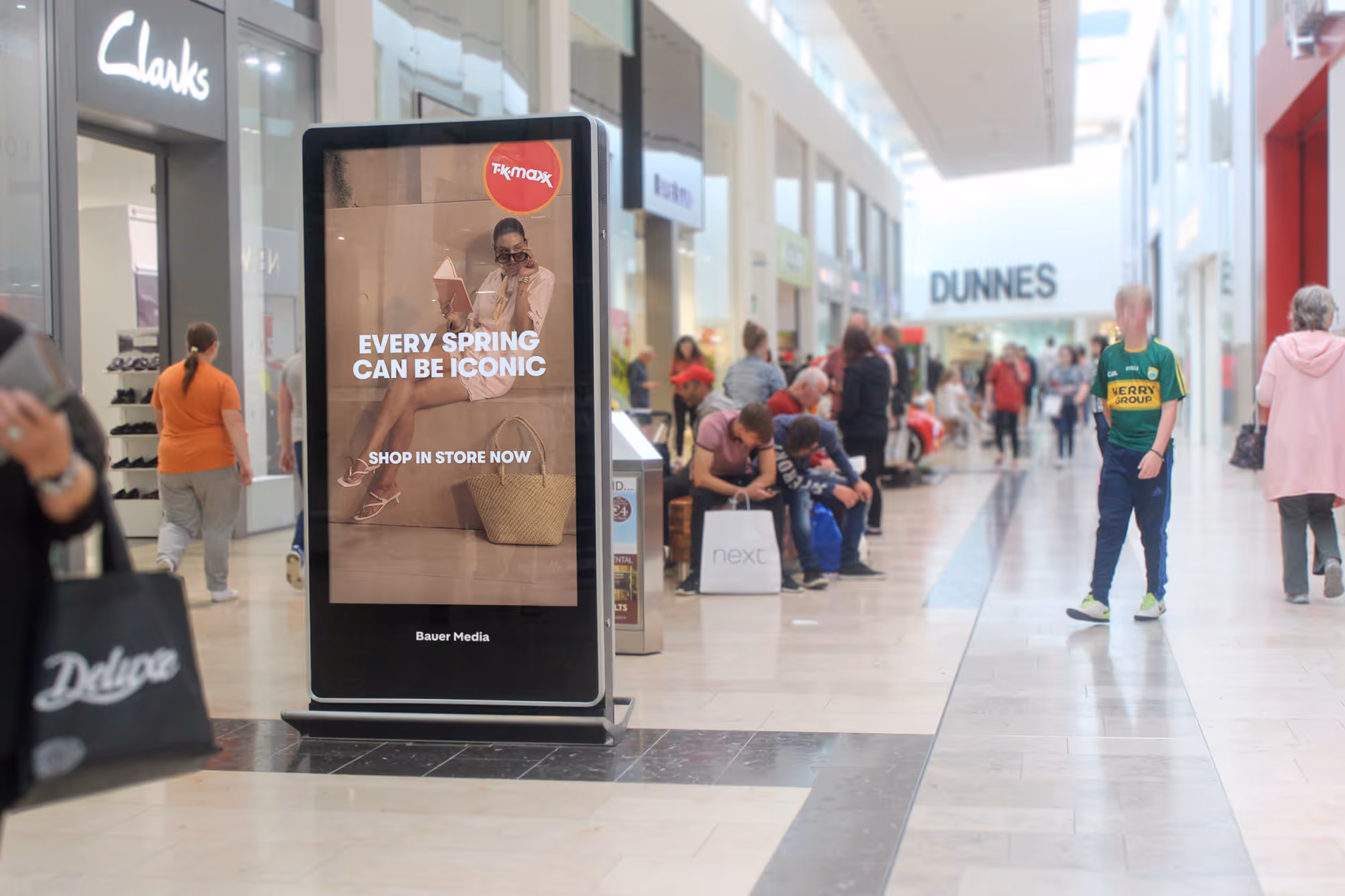 An Adshel Live Retail screen locatedin a busy shopping mall displaying an advert for TK Maxx