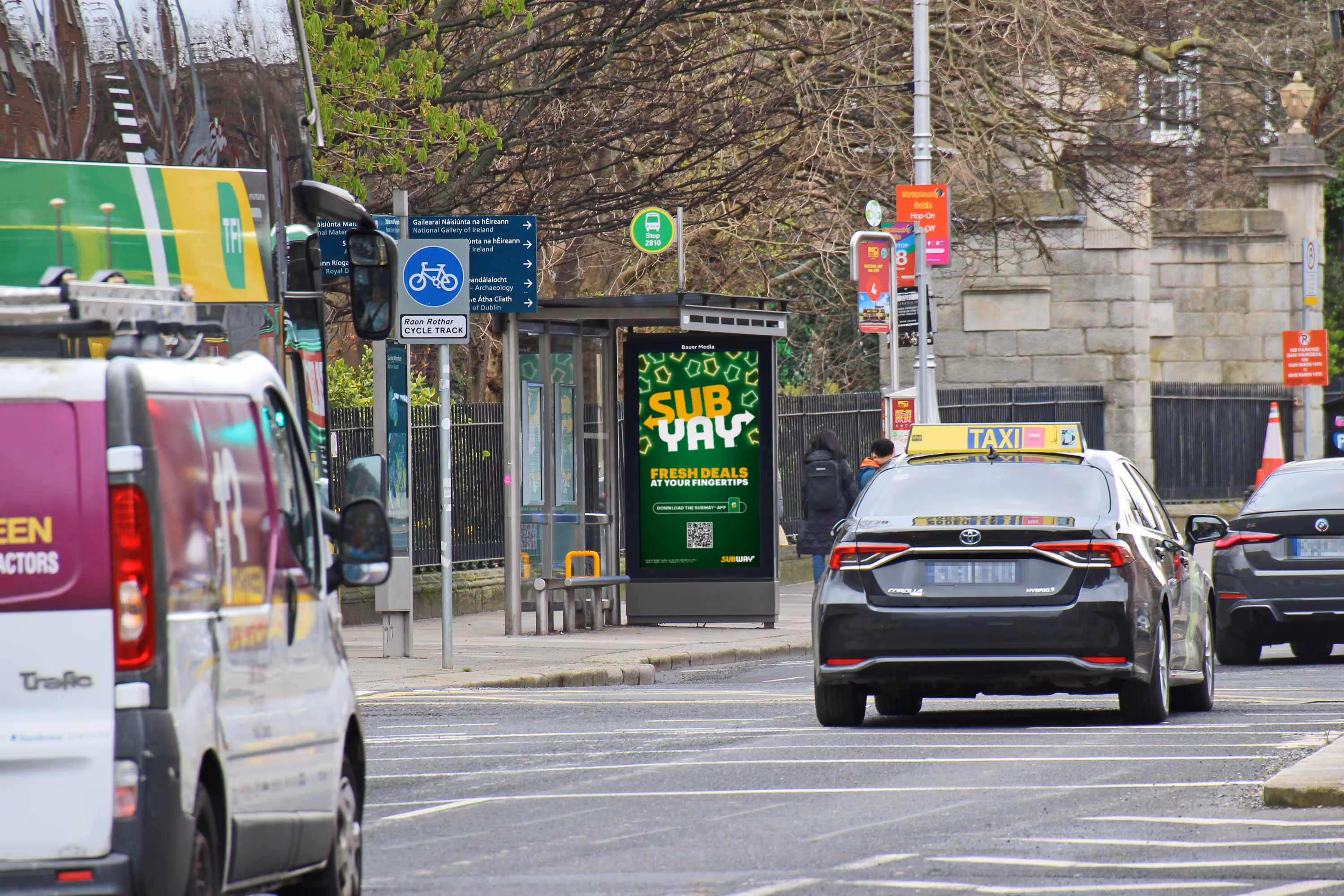 An Adshel Live digital bus shelter on a busy Dublin city centre street