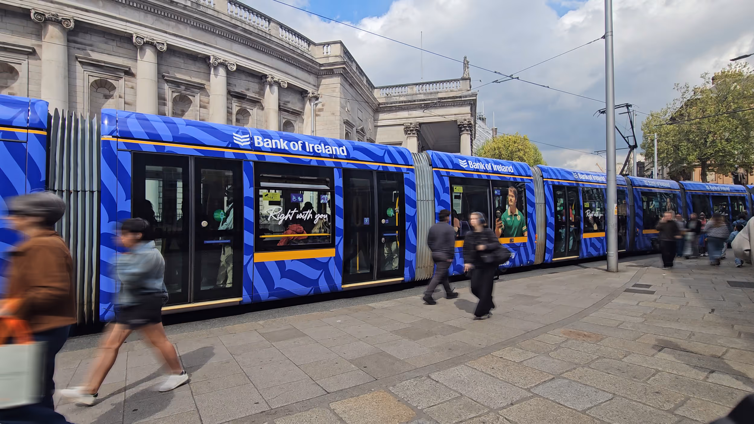 A Luas Column displaying an advertisement for Virgin Media Mobile, situated on the tram platform at St. Stephen's Green