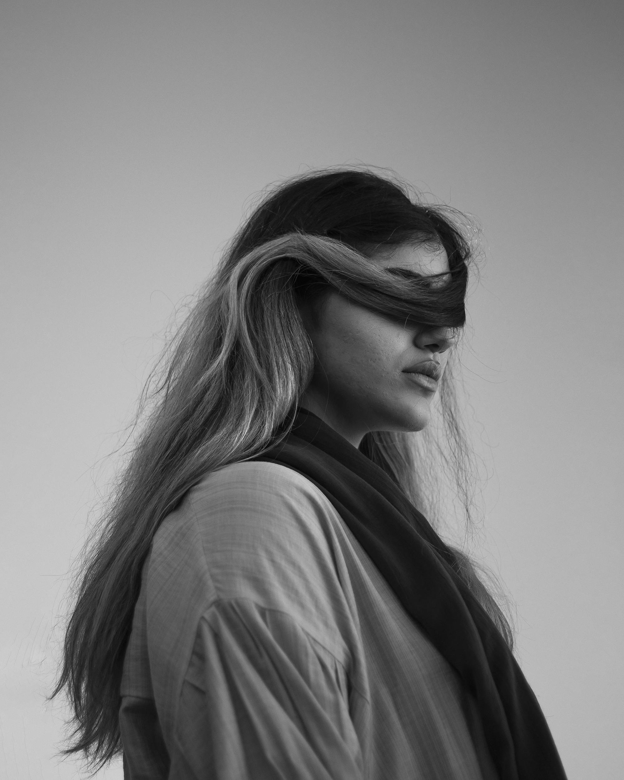 Unrecognizable woman with hair shielding her eyes