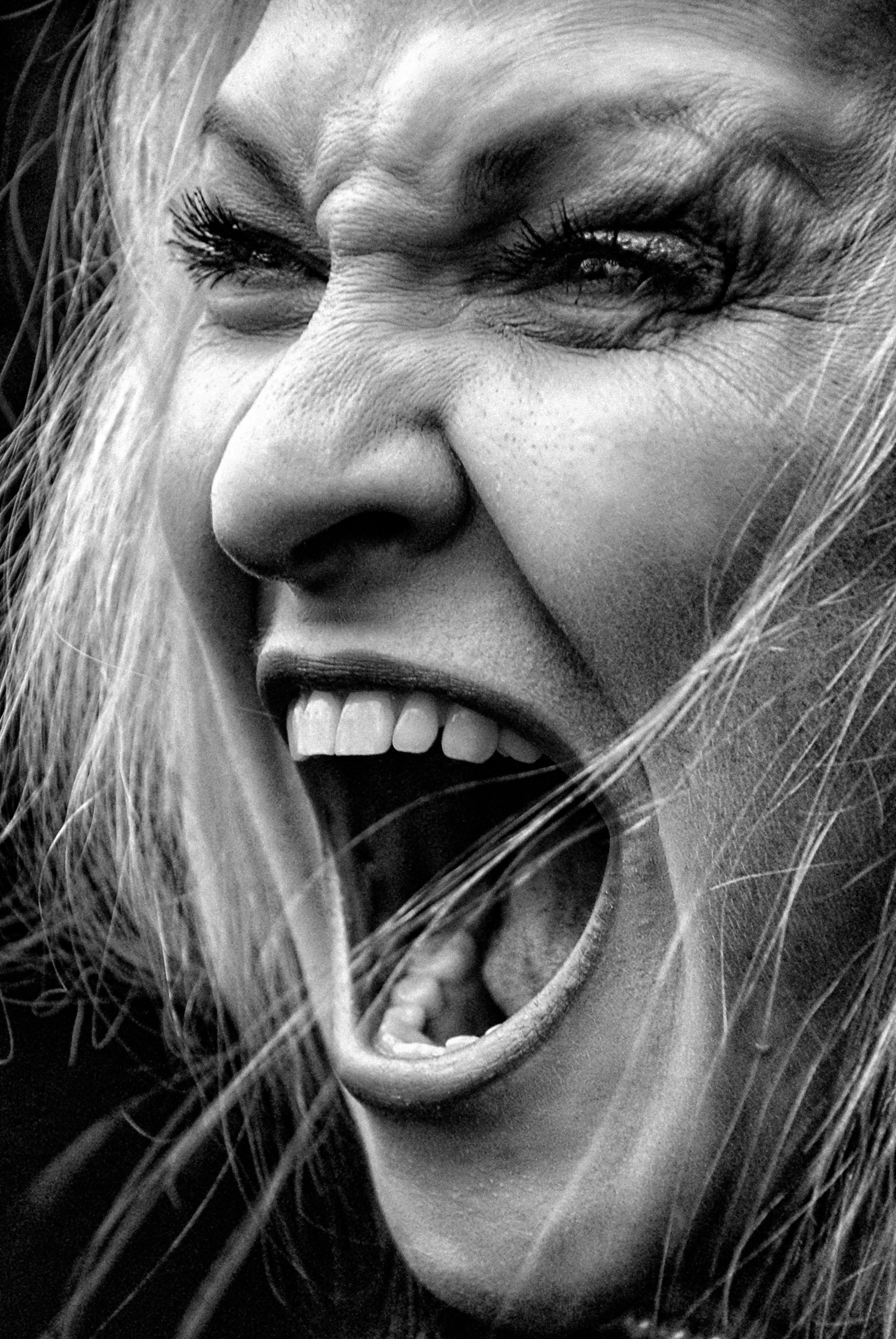 Black and white image of a woman yelling in rage