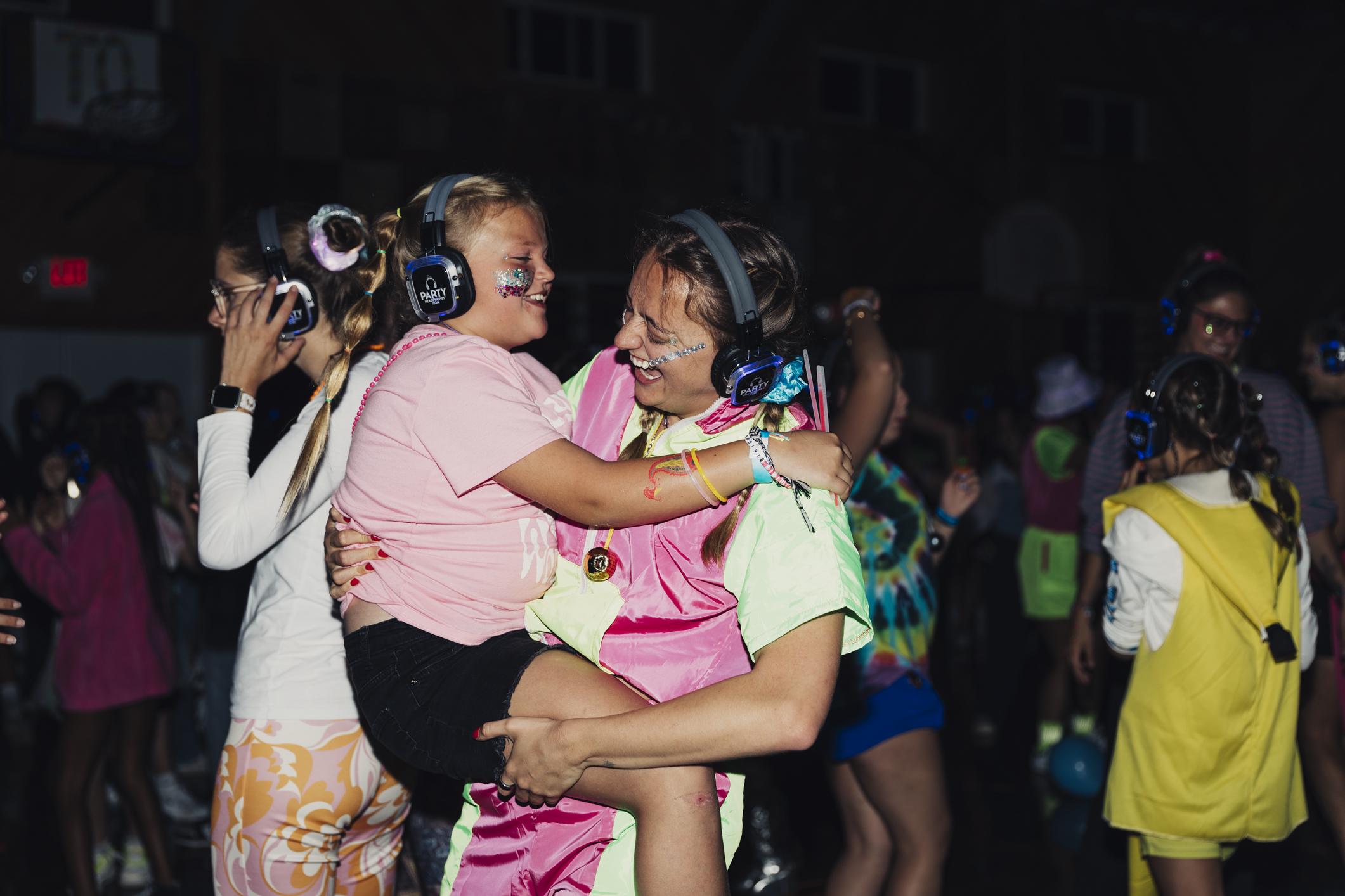 Emma doing an activity with a young women at camp