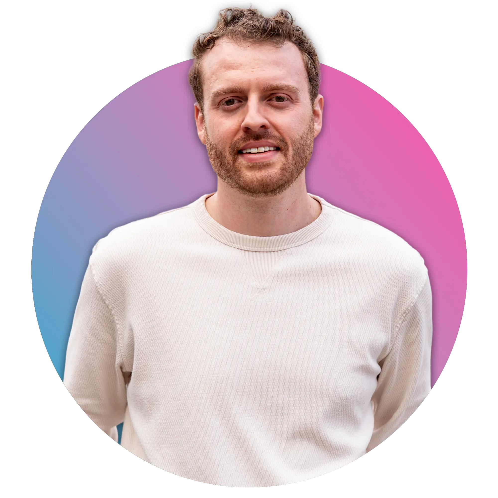 Man with curly hair and beard wearing a white sweater smiling against a gradient blue to pink circular background.
