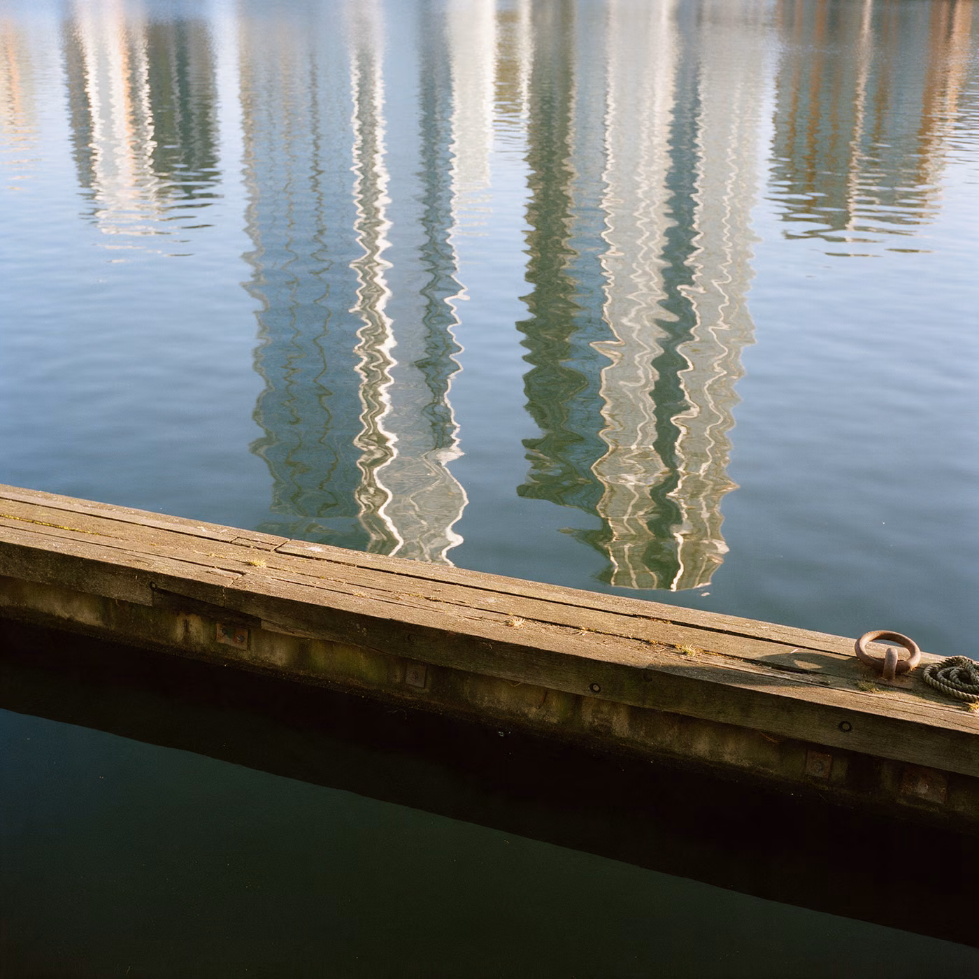 IT support East London: Canary Wharf towers reflected in West India Dock