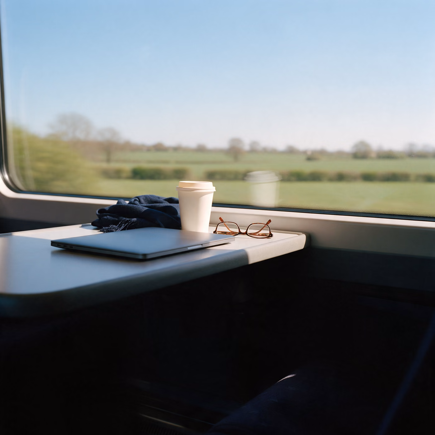 IT support Reading: a laptop and coffee on a train table between Reading and London