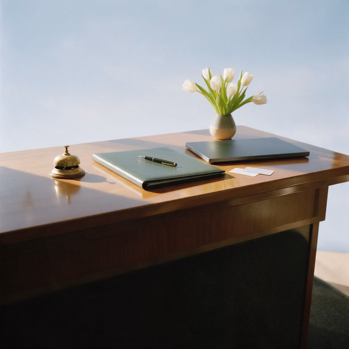 IT support Windsor: a hotel reception desk with a brass bell and white tulips