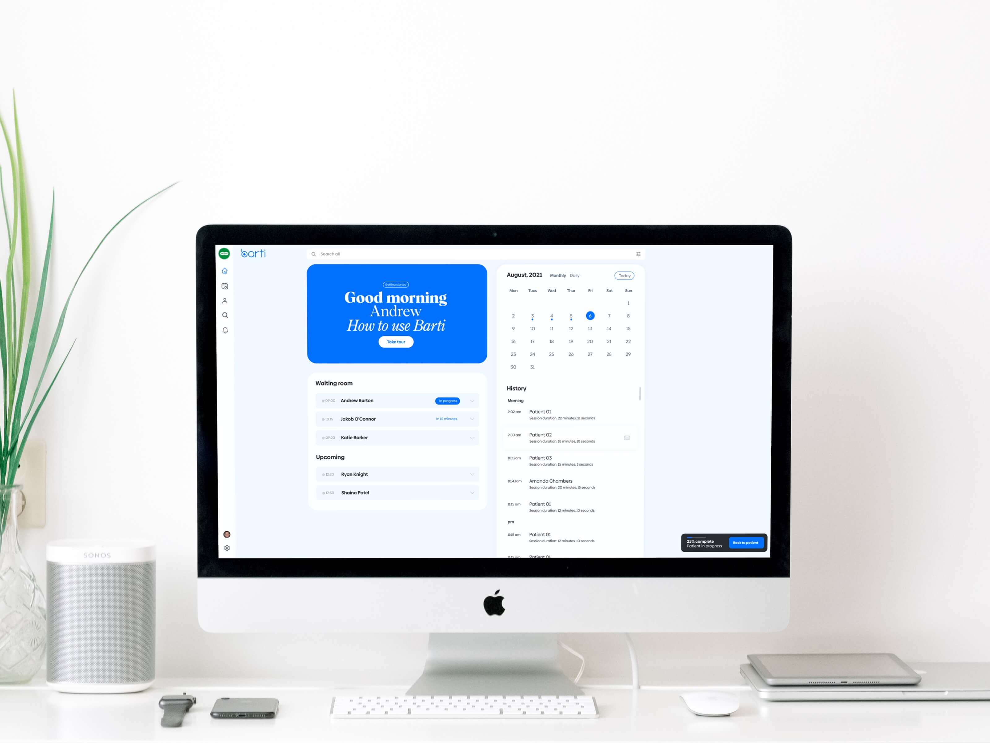 Photograph of desktop computer with screen showing Barti's dashboard 