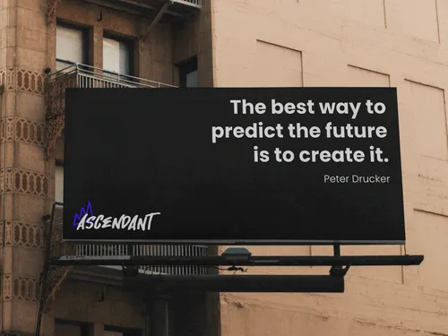 Photograph of a billboard that says "the best way to predict the future is to create it" and has the Ascendant logo.