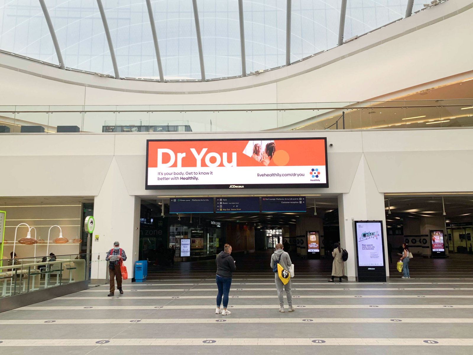 Photograph of a Healthily digital ad on a train station