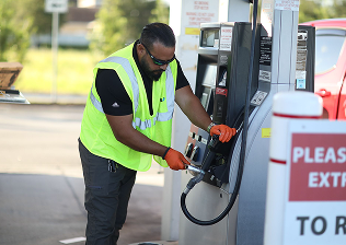 Aerial view of a shoreline with boats near a sandy beach and marshland.