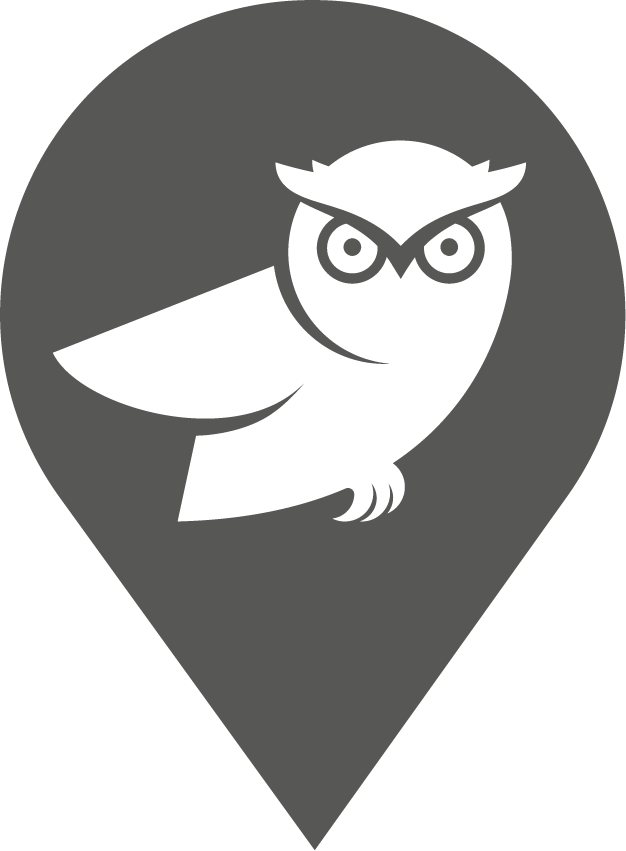 White stylized owl inside a dark gray map location pin.