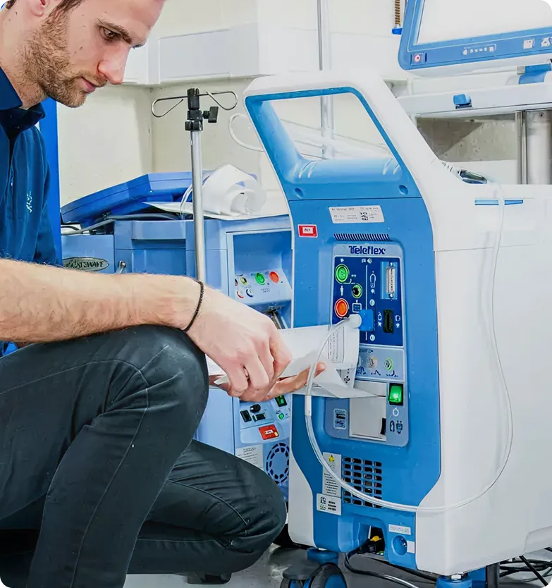 Technician performing maintenance on a medical oxygen concentrator