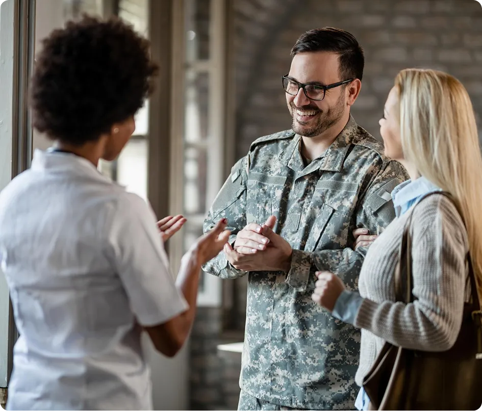 Veteran speaking with a healthcare professional alongside a family member