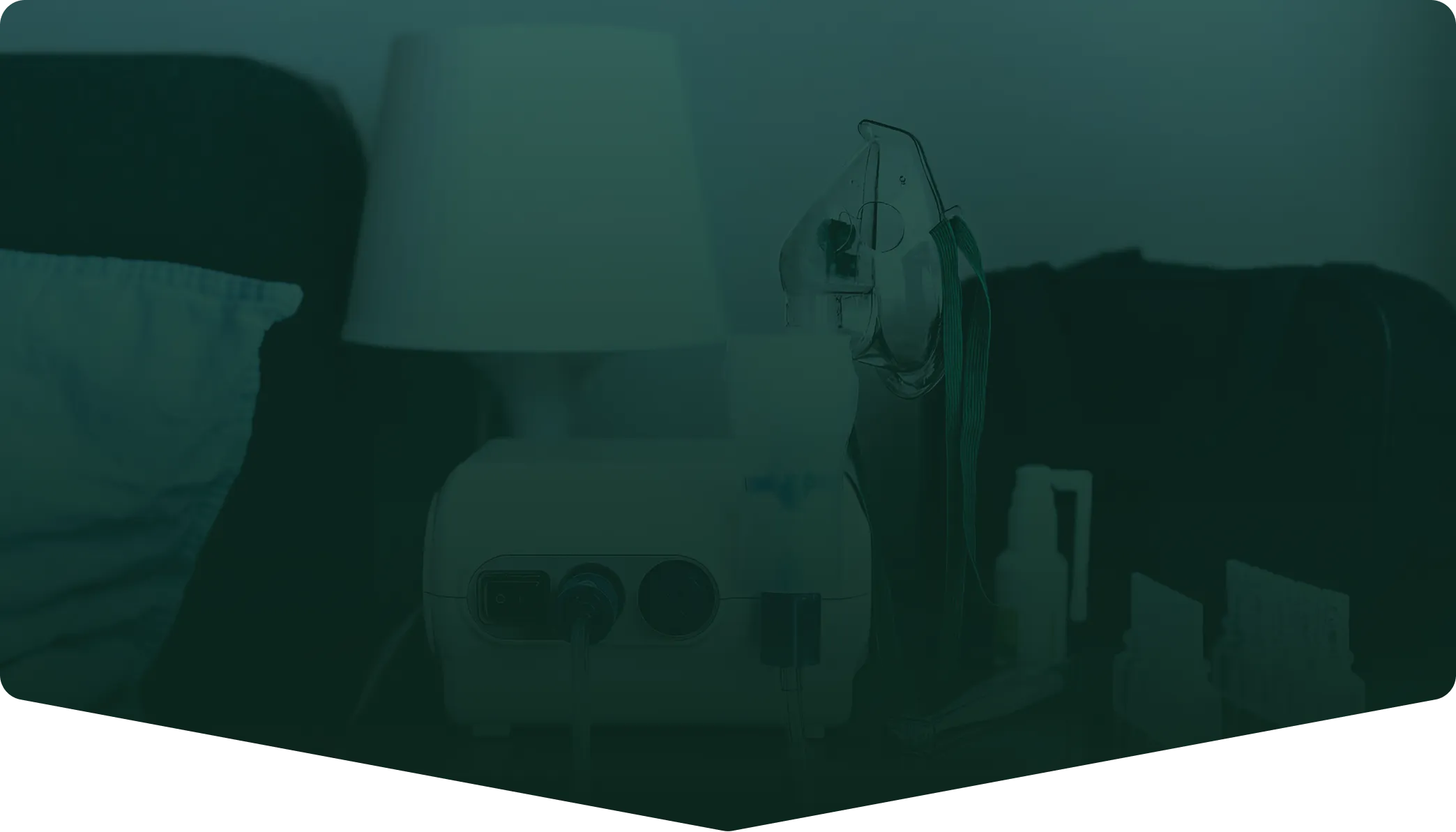 Home nebulizer machine with mask and accessories on a bedside table