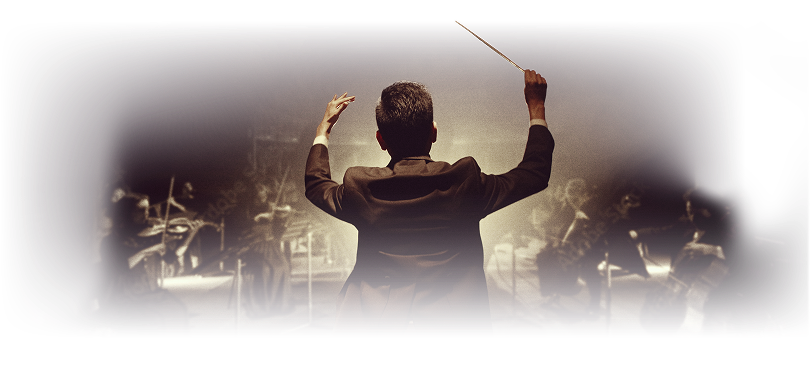 Conductor leading an orchestra with musicians playing string instruments in dim, dramatic lighting.
