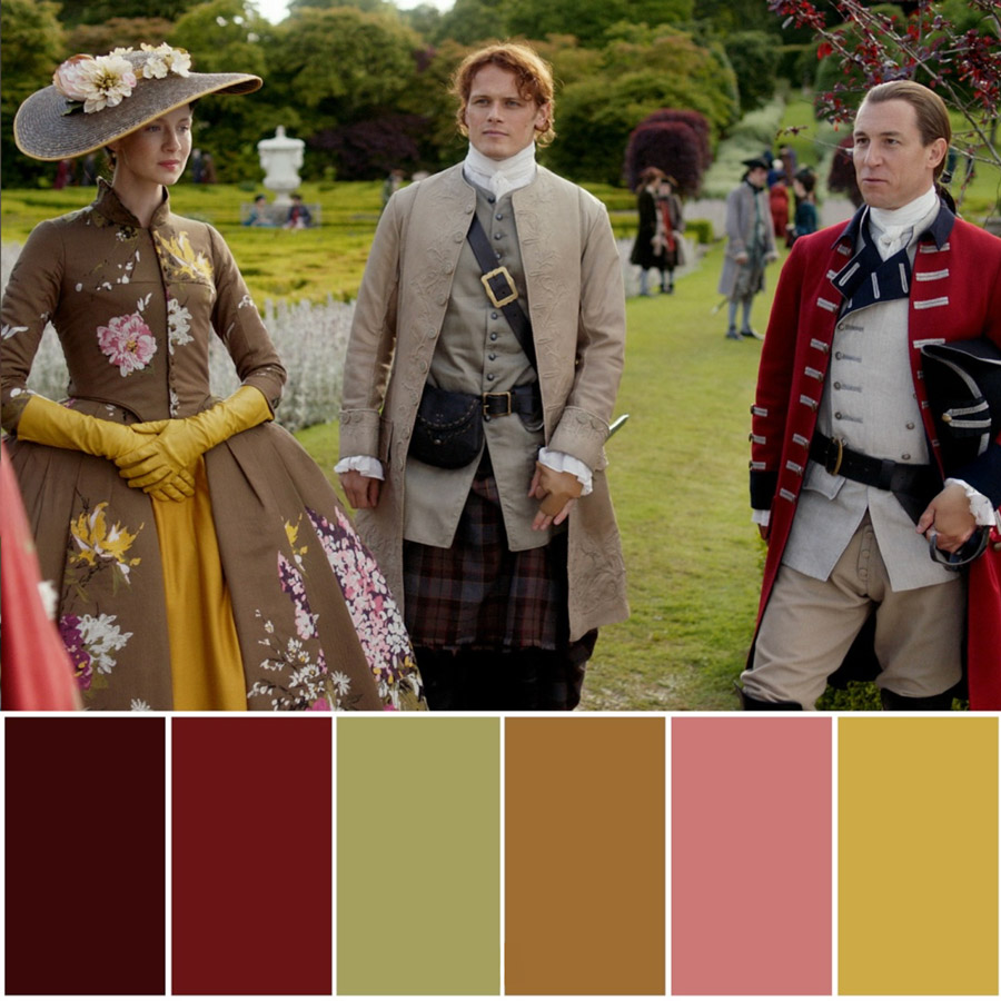 Three people in 18th-century attire stand outdoors in a garden, including a woman in a floral brown dress with a wide hat, a man in a beige coat and kilt, and a man in a red military coat.