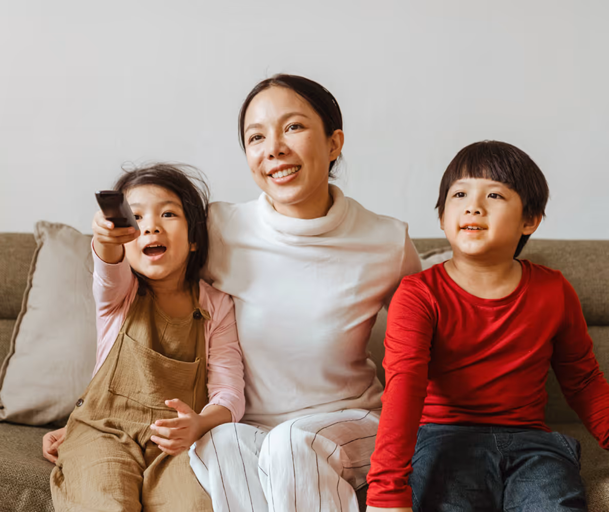 Mom watching CatholicTV with her kids
