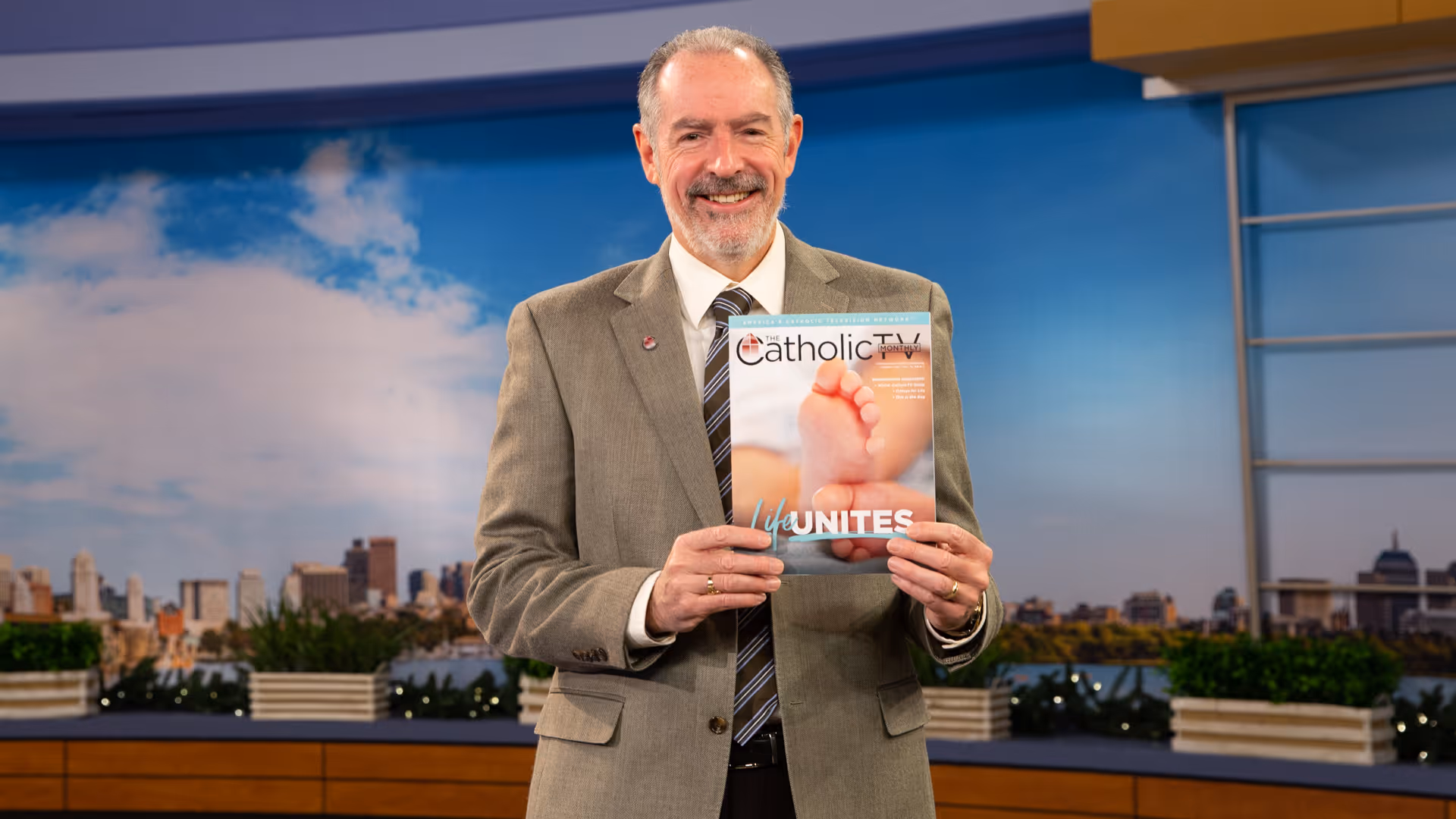 Kevin Nelson holding an issue of The CatholicTV Monthly Magazine