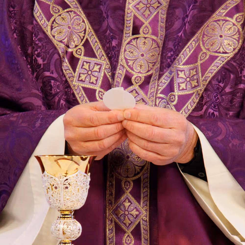 Close-up of a priest holding the Eucharistic host at Mass