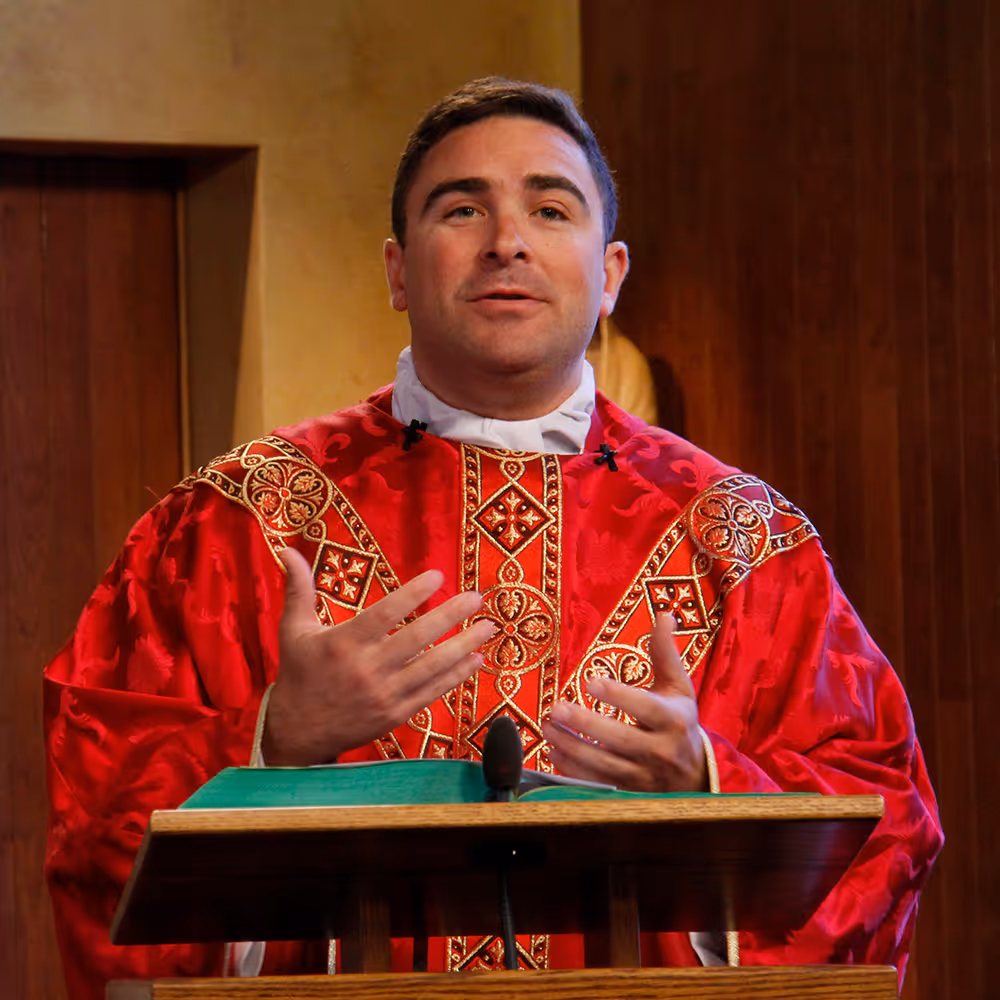 Priest giving a homily at the CatholicTV Mass
