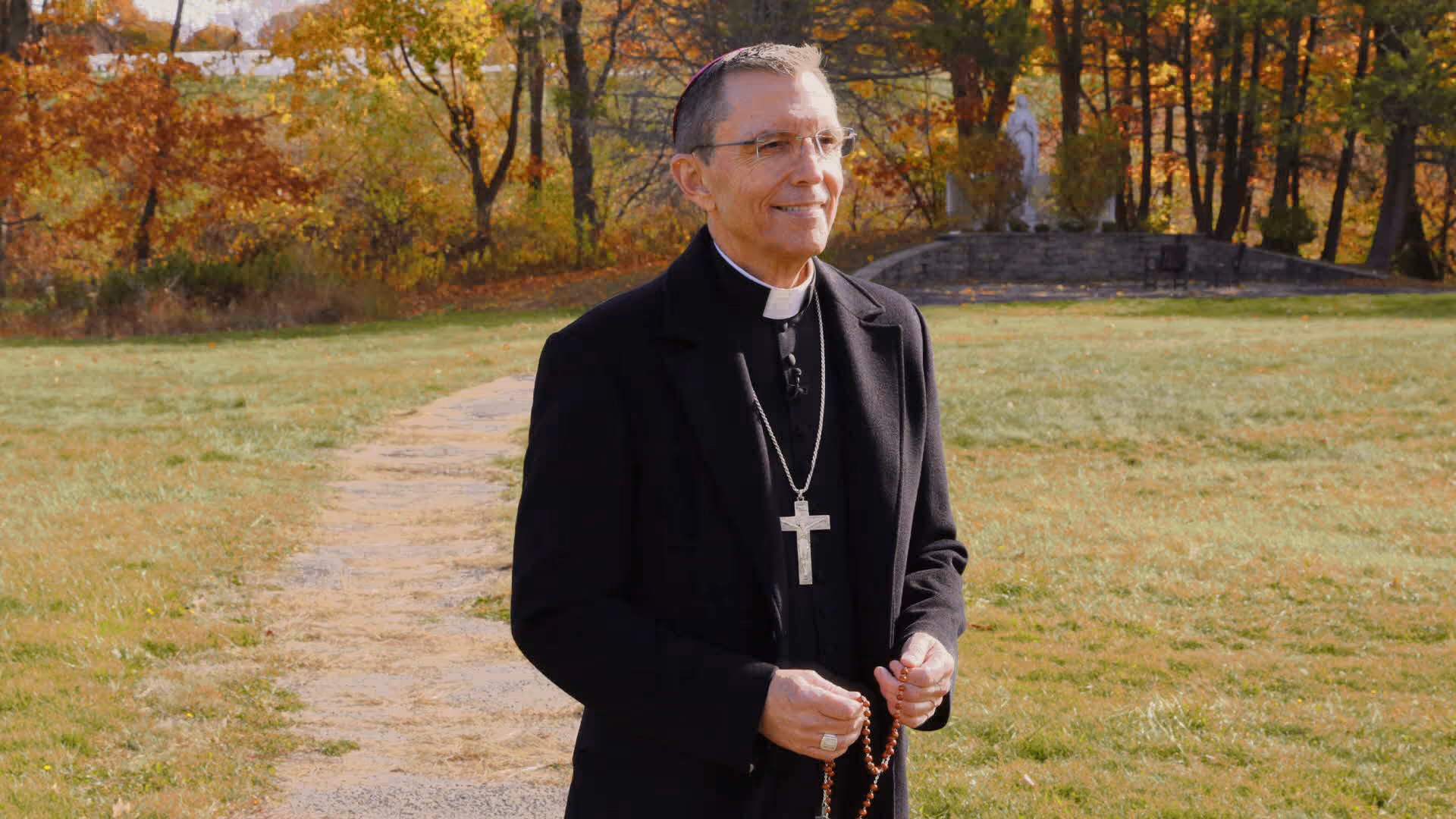 Bishop Robert Reed holding Rosary beads