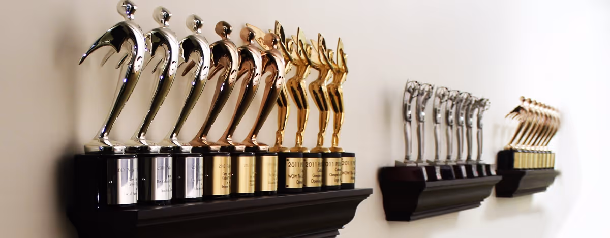 Trophy awards lined up against a wall