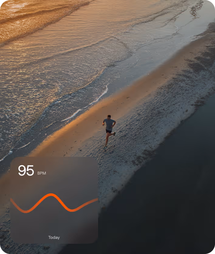 Person running on the beach at sunset alongside a visualization of their heart rate data