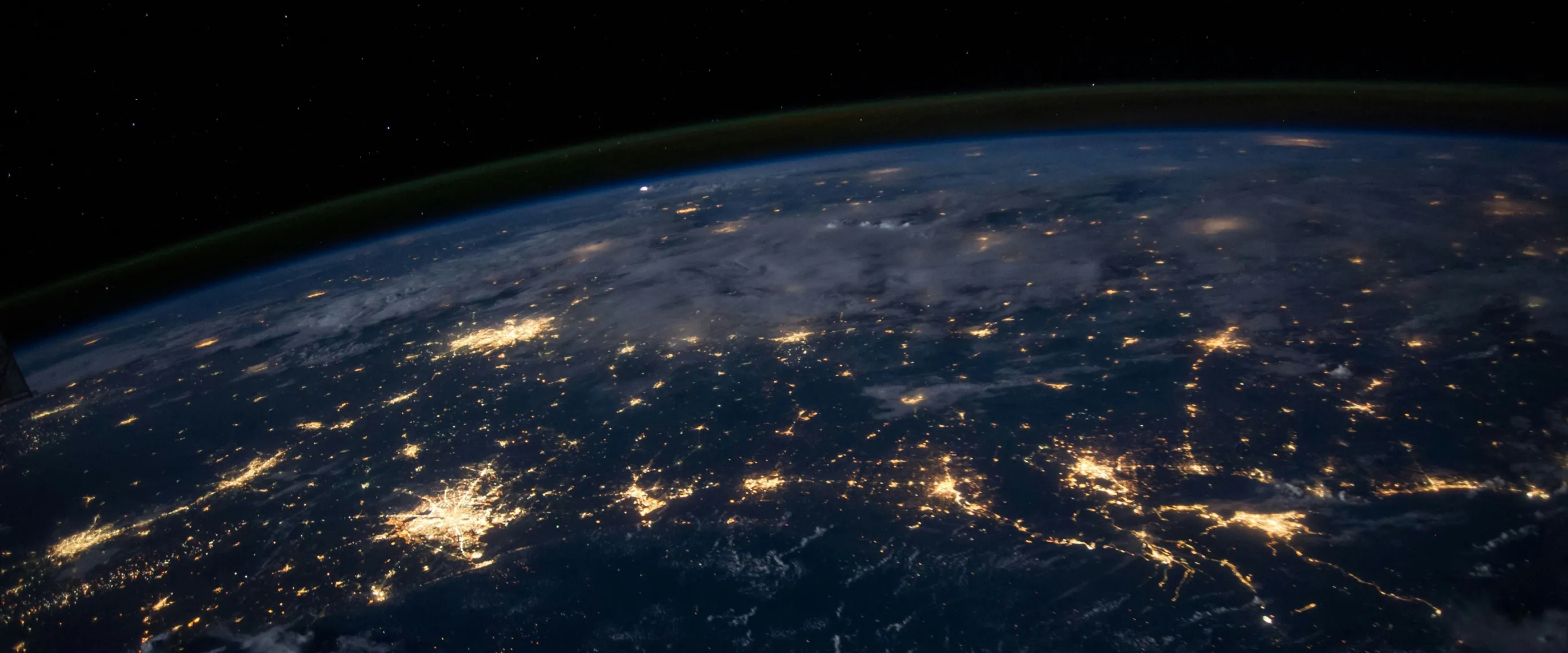 Earth at night with glowing city networks — IT, data and blockchain connectivity