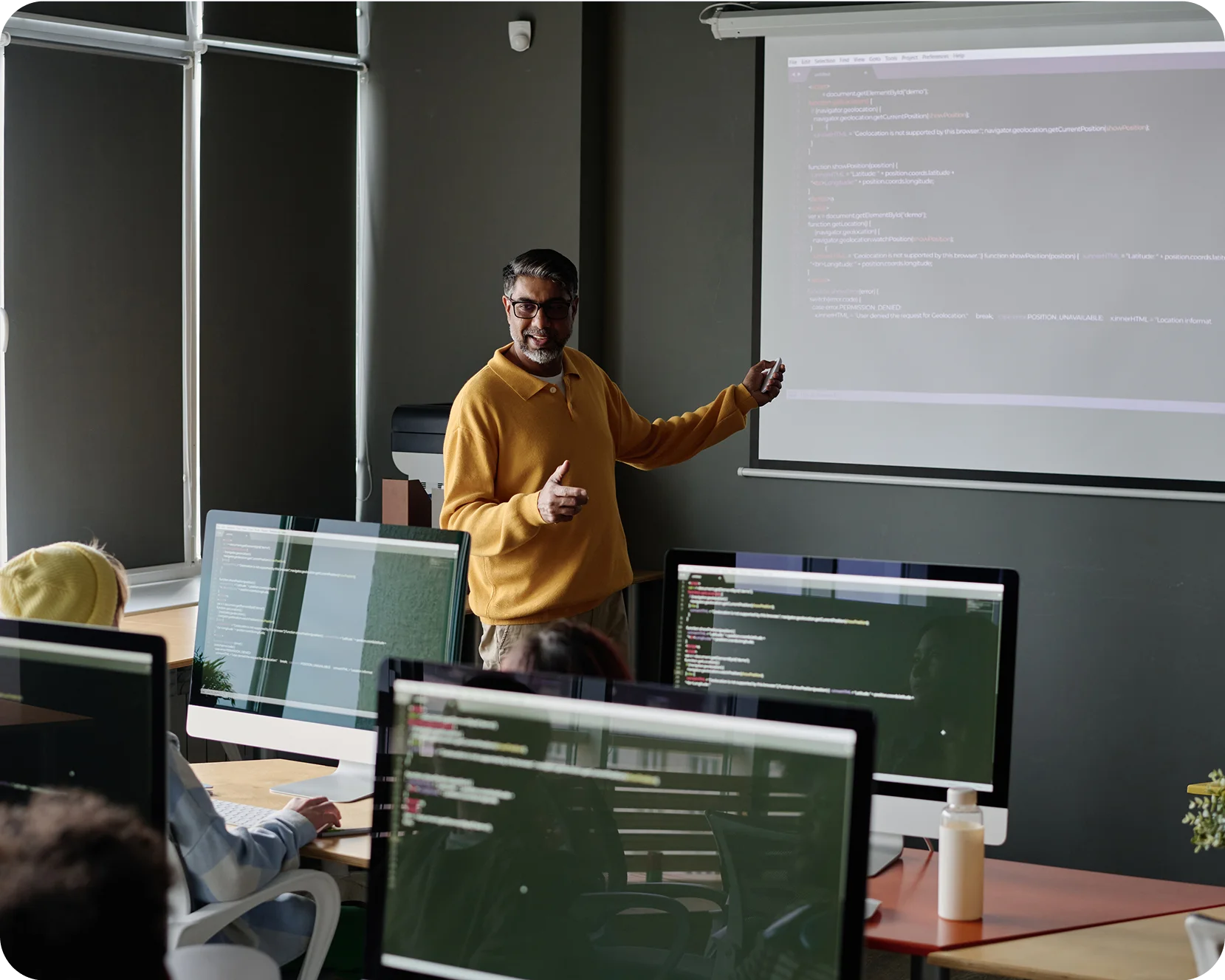 a man standing in front of a screen