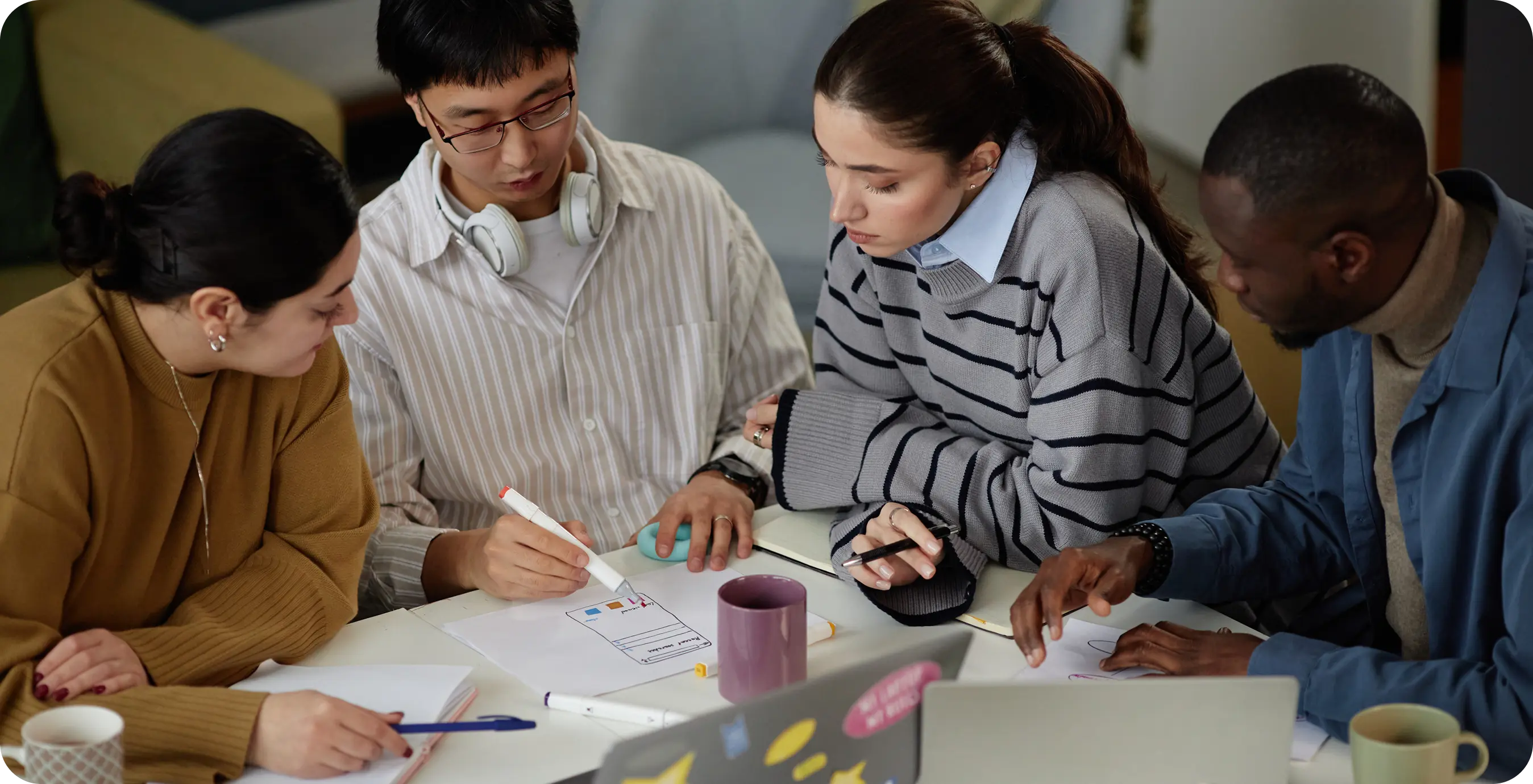 a group of people sitting at a table looking at a piece of paper