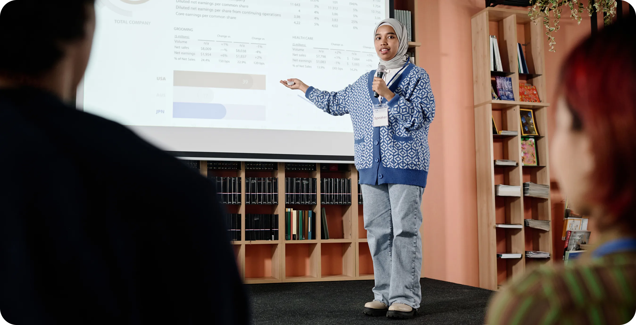 a girl standing in front of a screen