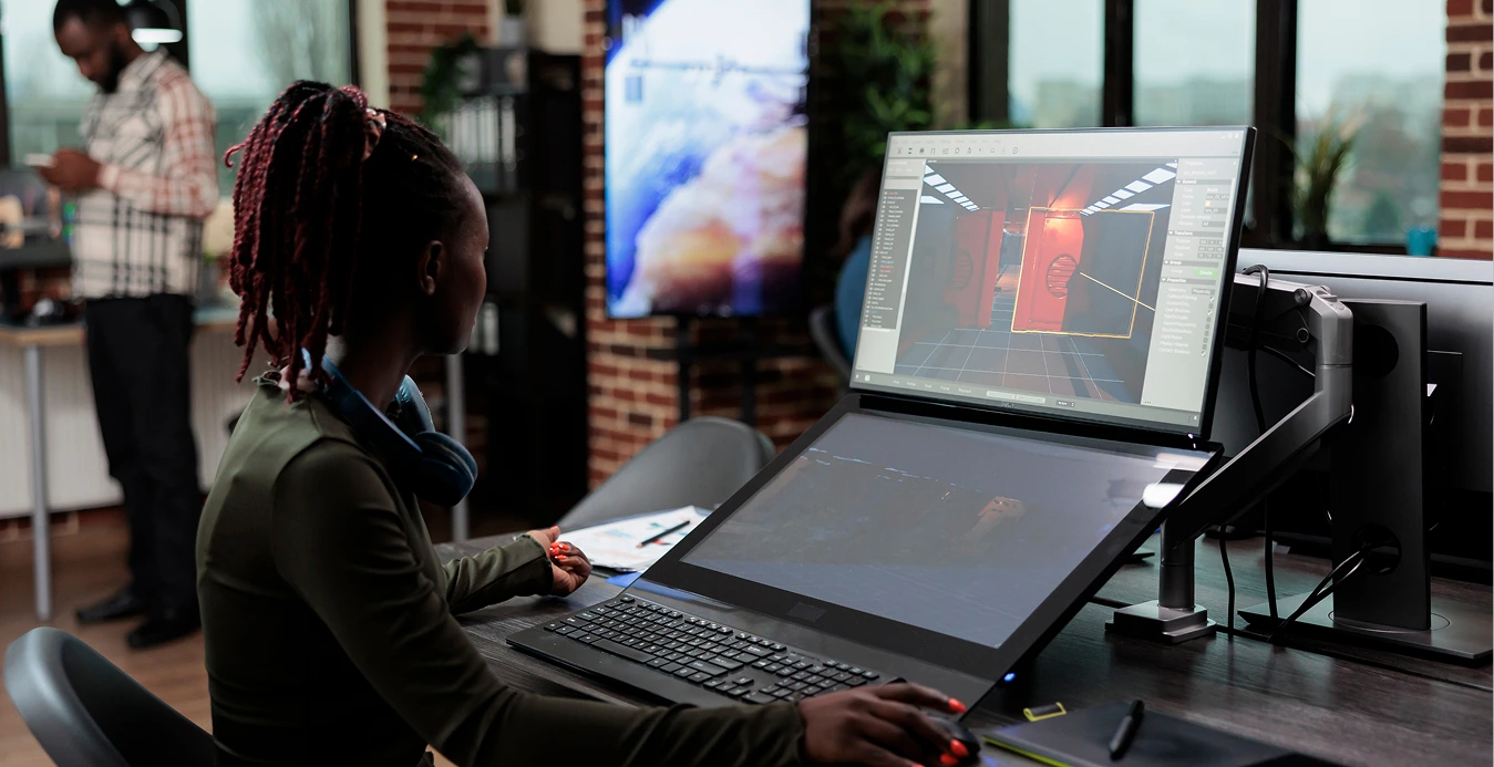 a woman sitting at a desk with a computer