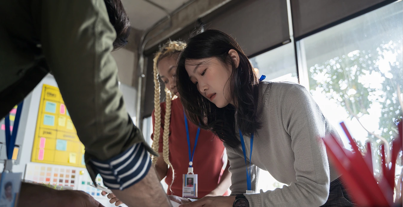 a group of people looking at a piece of paper
