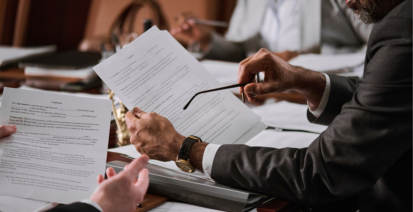 a man holding glasses over a piece of paper
